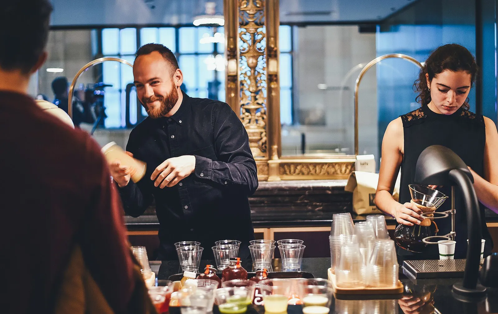 Cocktails being prepared at an American bar counter