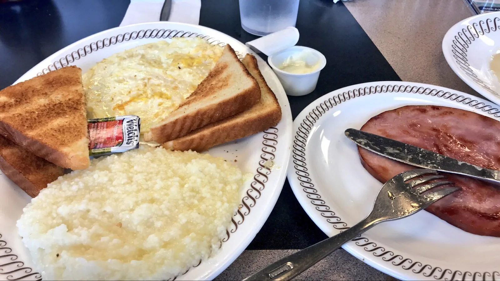 Classic American diner breakfast with eggs, hash browns, toast and coffee on a counter