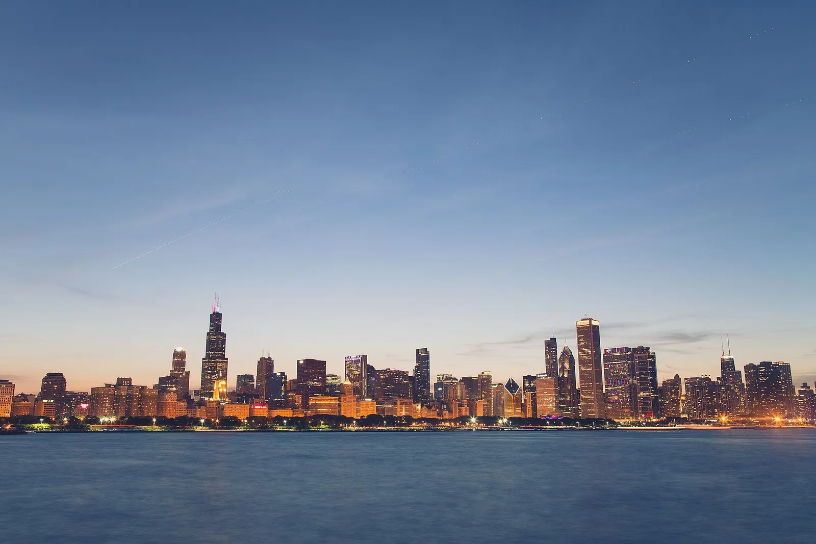 Chicago skyline seen across Lake Michigan with the downtown towers reflected in the water