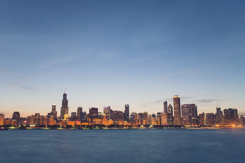 Chicago skyline seen across Lake Michigan with the downtown towers reflected in the water