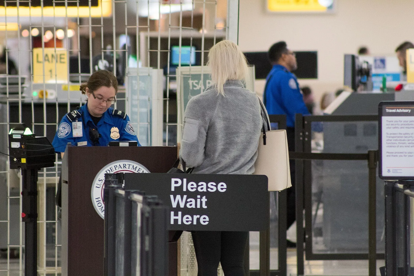 International arrivals hall with a long queue of travelers waiting for passport inspection at a US airport