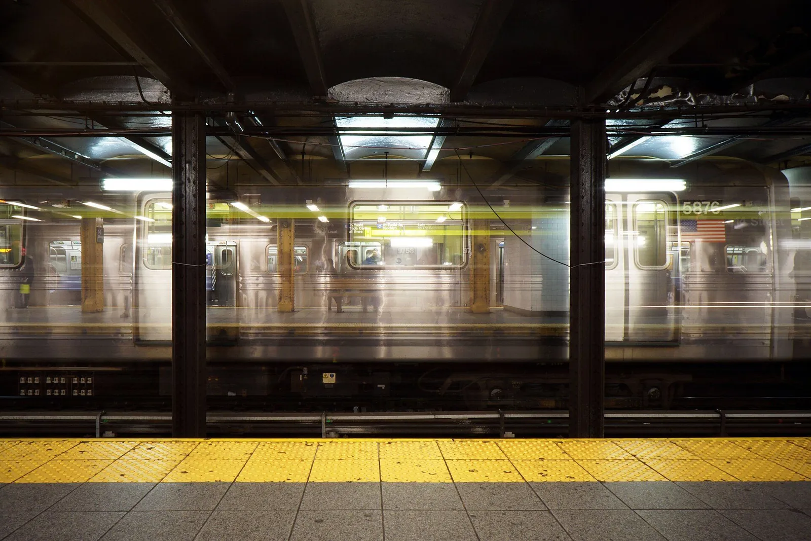 Passengers waiting on a modern light rail station platform in an American city