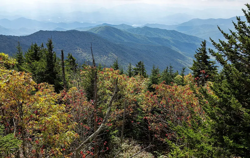 Layered smoky mountain ridges fading into morning mist