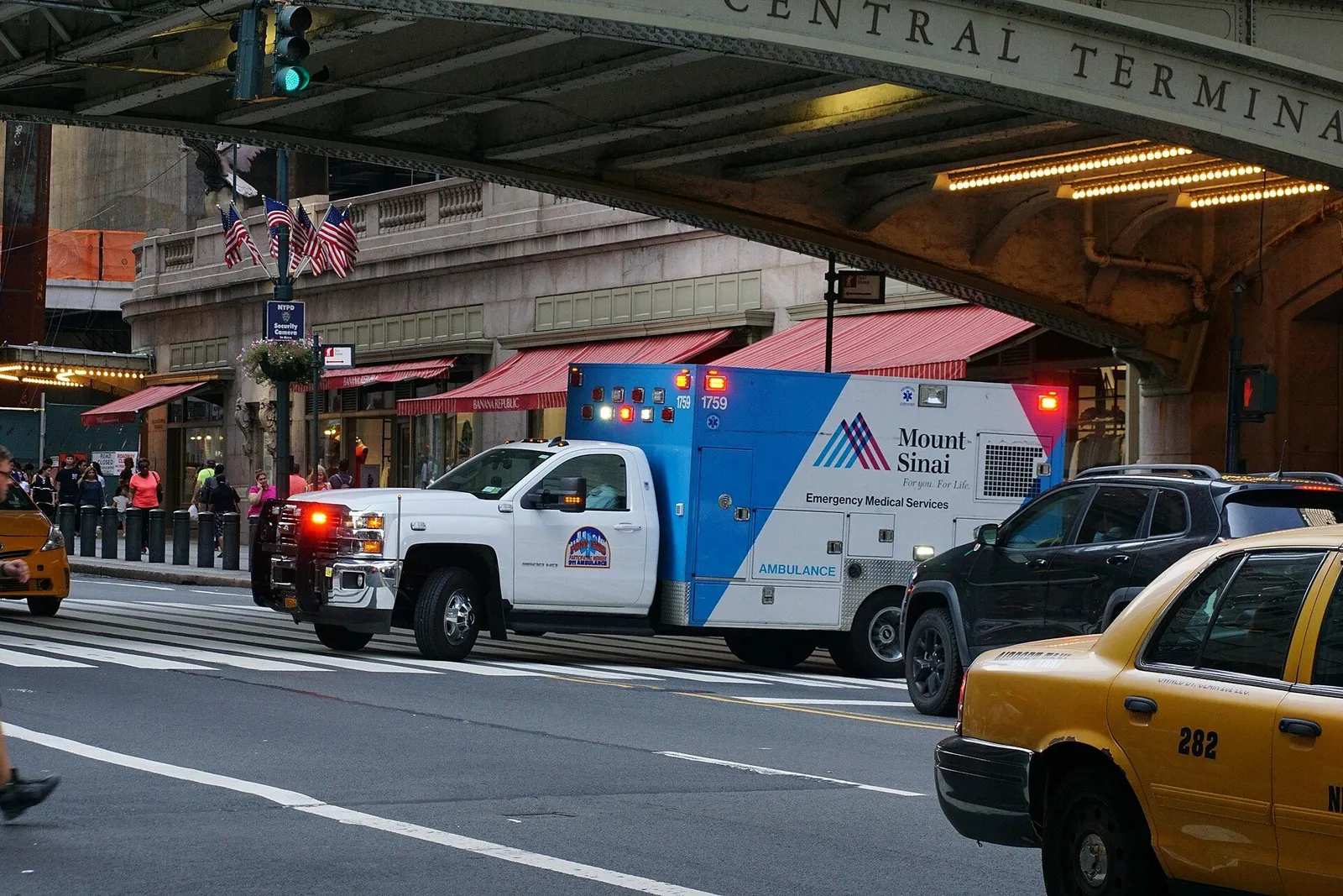 Ambulance parked outside a hospital emergency department entrance at dusk