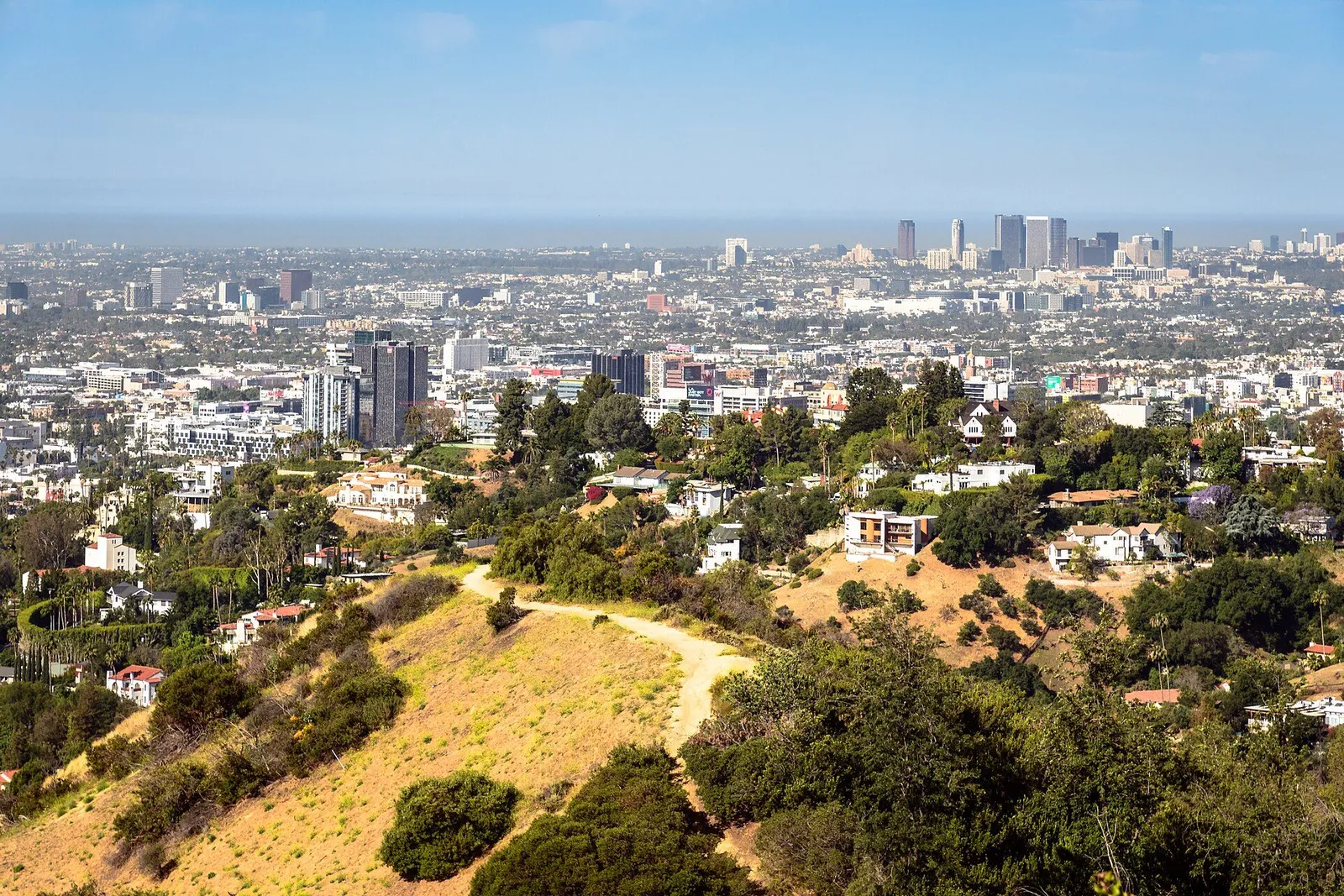 The Los Angeles skyline beneath the Hollywood Hills on a clear day