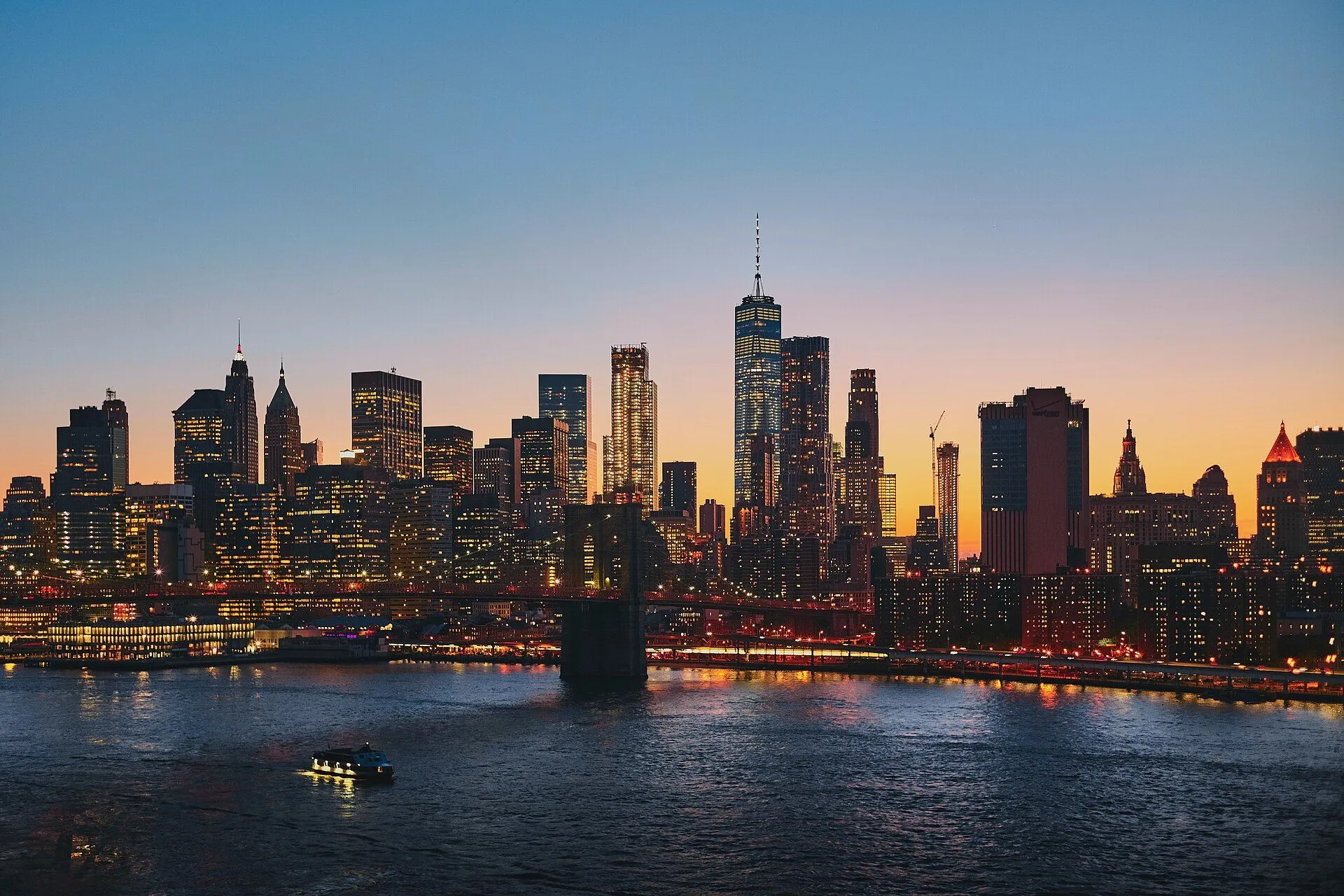 Lower Manhattan and the Brooklyn Bridge at dusk, seen across the East River