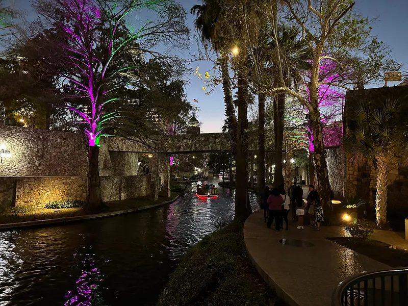 San Antonio River Walk at dusk with stone banks and riverside trees