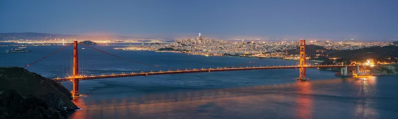 The Golden Gate Bridge in fog with the city of San Francisco behind it