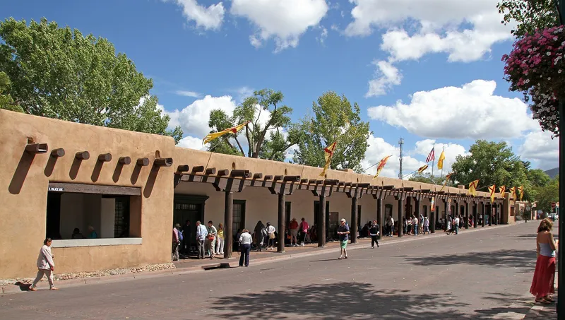 Low adobe buildings of Santa Fe with the Sangre de Cristo Mountains behind them