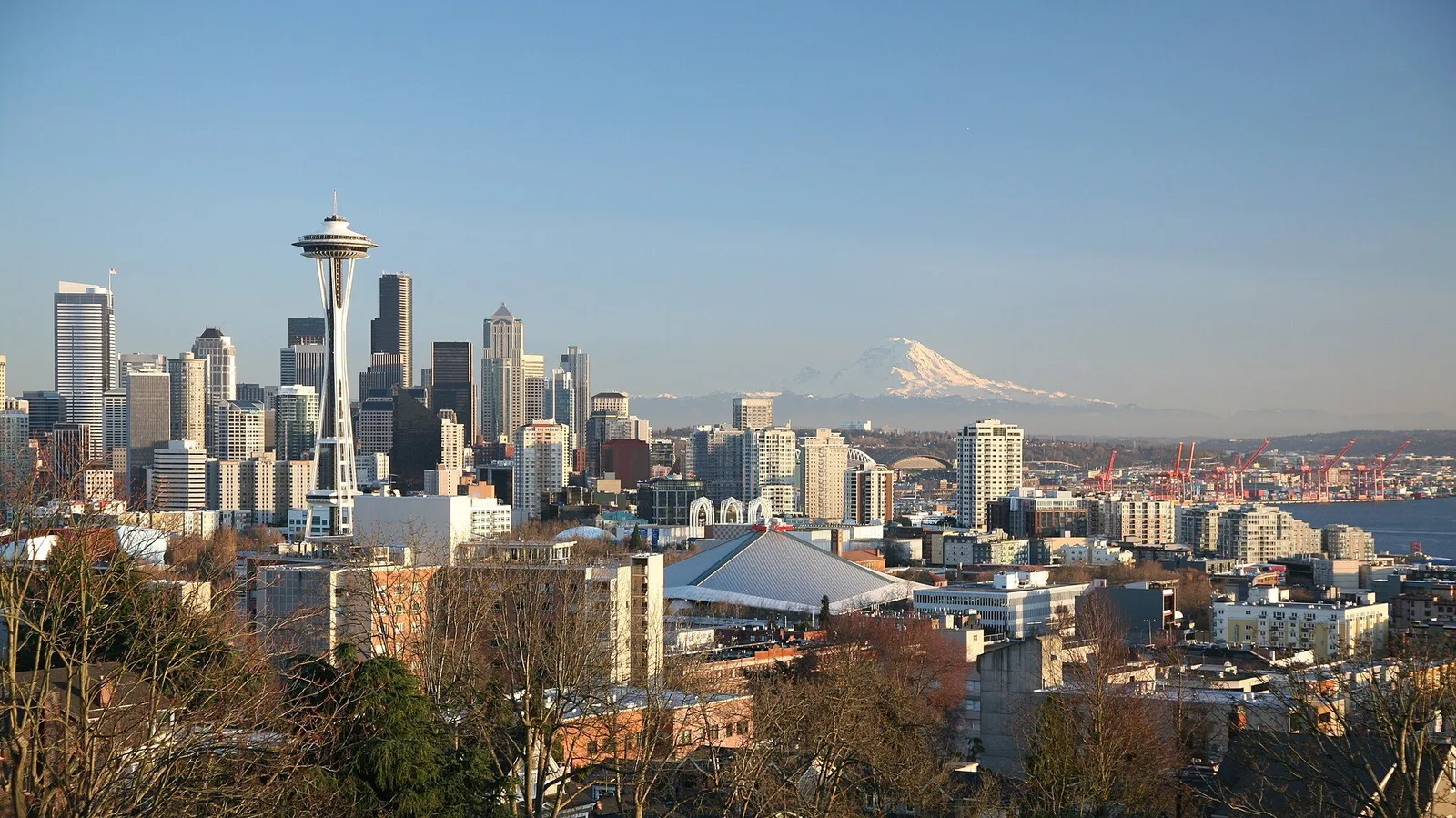 The Seattle skyline seen across Elliott Bay with the Space Needle and Mount Rainier behind it