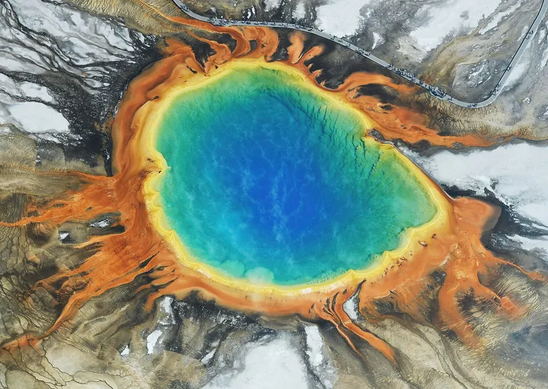 Grand Prismatic Spring's blue center ringed by bands of orange and green bacteria mats